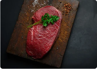 Raw beef steak on a wooden board