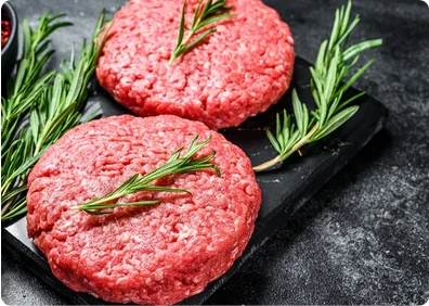 Raw burger patties with rosemary