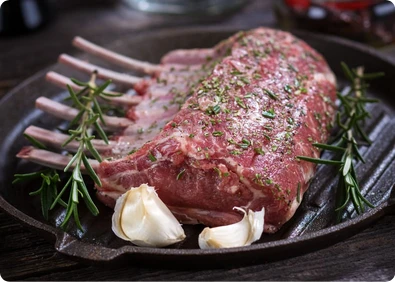 Raw rack of lamb in a skillet