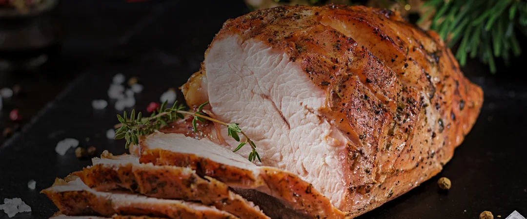 Roasted turkey breast with golden skin, sliced ready to serve